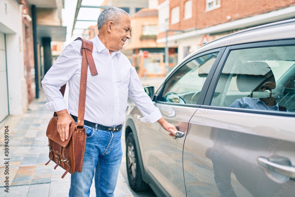 Senior man smiling happy opening car at the city. Senior man smiling happy opening car at the city.