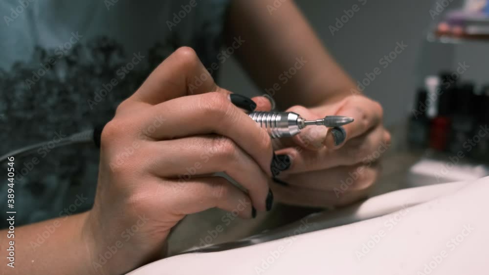 Beauty and healthcare concept. 4k. Hardware manicure, removing gel polish from nails at home, top view Beauty and healthcare concept. 4k. Hardware manicure, removing gel polish from nails at home, top view