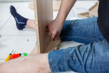 Assembling of furniture with his own hands at home, close up