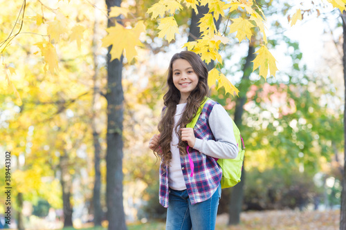 autumn kid fashion. romantic season for inspiration. happy childhood. back to school. teenage girl with backpack relax walking in park. fall season beauty. enjoy day in forest