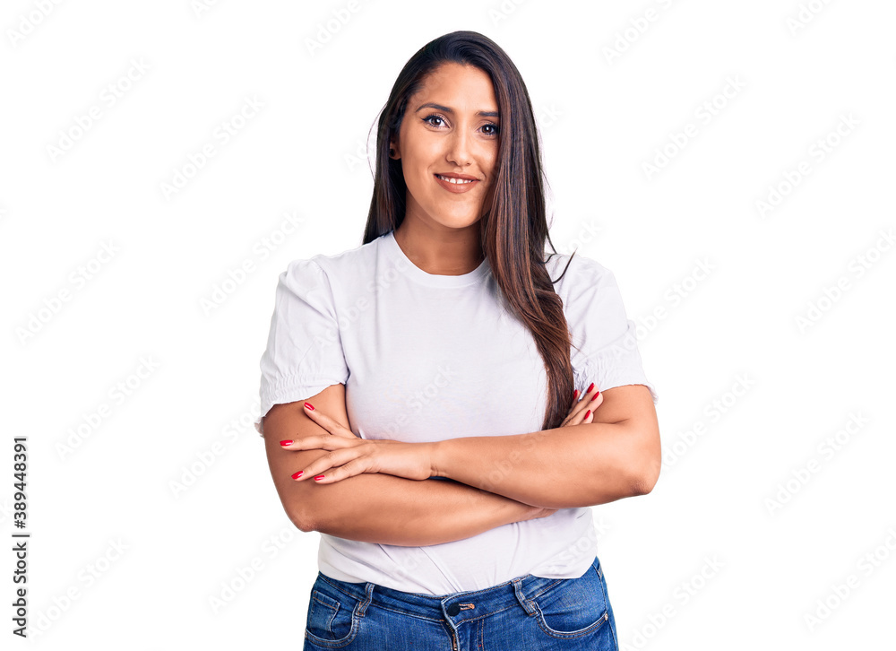 Young beautiful brunette woman wearing casual t-shirt happy face smiling with crossed arms looking at the camera. positive person. Young beautiful brunette woman wearing casual t-shirt happy face smiling with crossed arms looking at the camera. positive person.