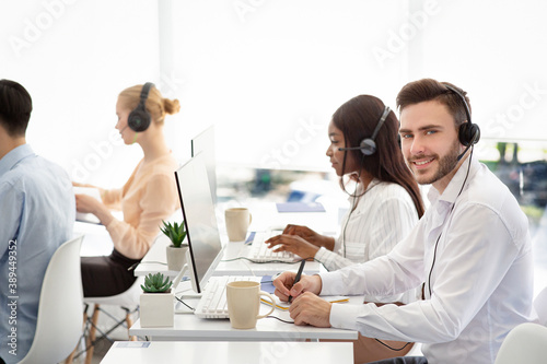 Diverse customer service operators helping clients, resolving technical issues or selling goods at call centre