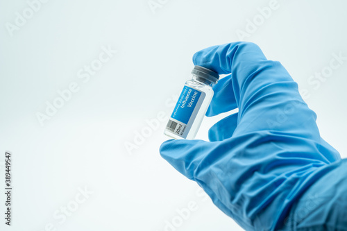 a medic holds a bottle of influenza vaccine