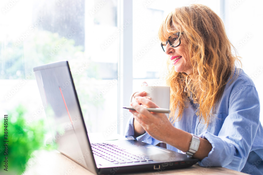 business woman with computer and coffee at home or online office business woman with computer and coffee at home or online office