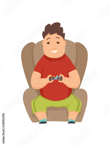 Overweight boy playing computer games and sitting in a soft chair.