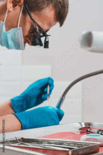 Tableau sur toile Patient and dentist, examination and treatment of masticatory teeth, removal of old fillings, use of a retractor
