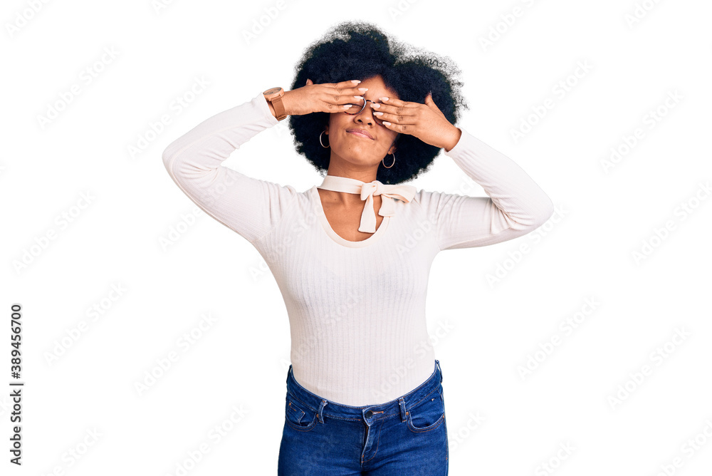 Young african american girl wearing casual clothes and glasses covering eyes with hands smiling cheerful and funny. blind concept. Young african american girl wearing casual clothes and glasses covering eyes with hands smiling cheerful and funny. blind concept.