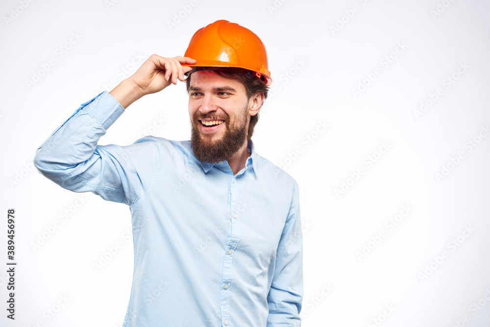 Cheerful man orange hard hat work industry professional lifestyle light background