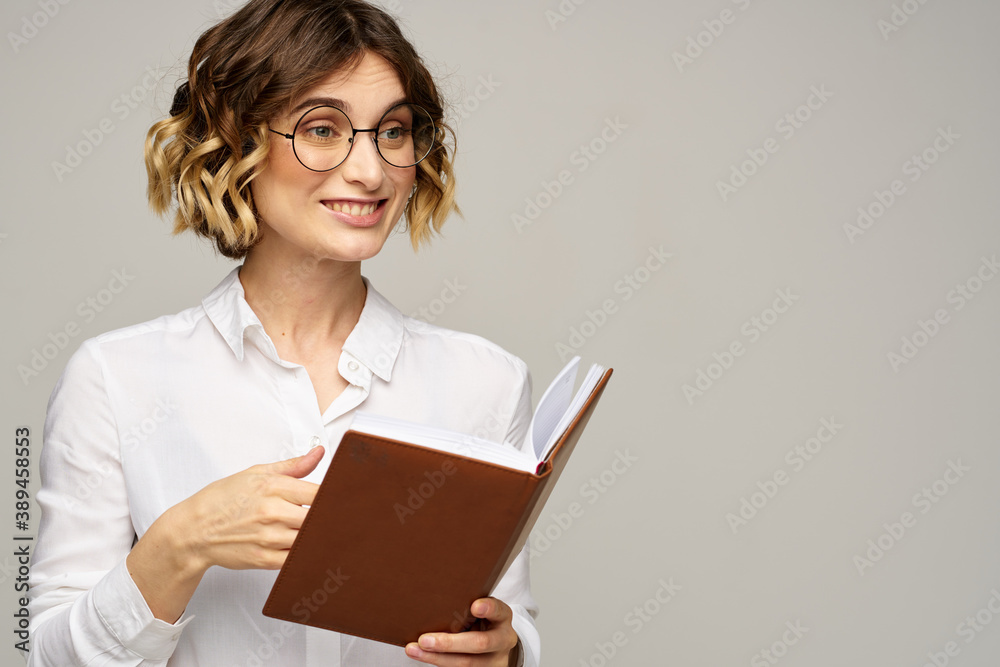 woman with notepad in hands business work beige background glasses hairstyle woman with notepad in hands business work beige background glasses hairstyle