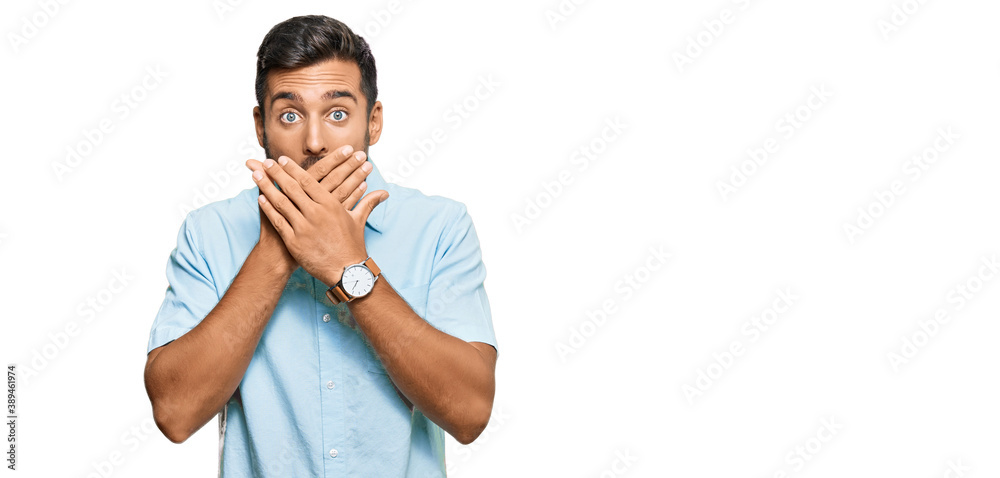 Handsome hispanic man wearing casual clothes shocked covering mouth with hands for mistake. secret concept. Handsome hispanic man wearing casual clothes shocked covering mouth with hands for mistake. secret concept.