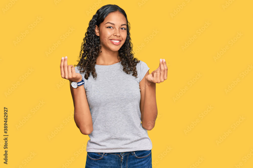 Young african american girl wearing casual clothes doing money gesture with hands, asking for salary payment, millionaire business Young african american girl wearing casual clothes doing money gesture with hands, asking for salary payment, millionaire business