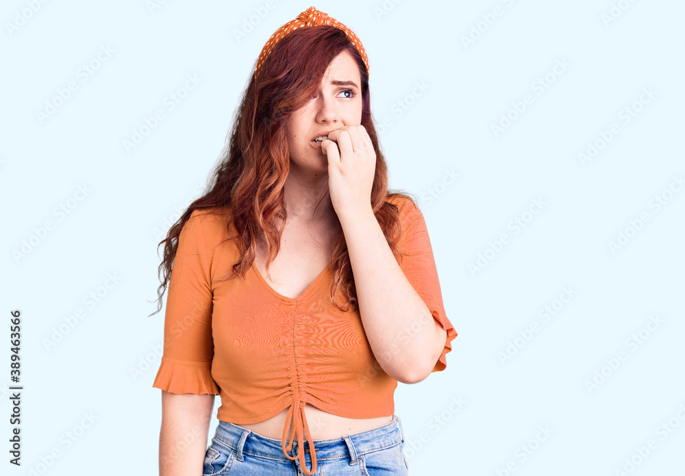 Young beautiful woman wearing casual clothes looking stressed and nervous with hands on mouth biting nails. anxiety problem. Young beautiful woman wearing casual clothes looking stressed and nervous with hands on mouth biting nails. anxiety problem.