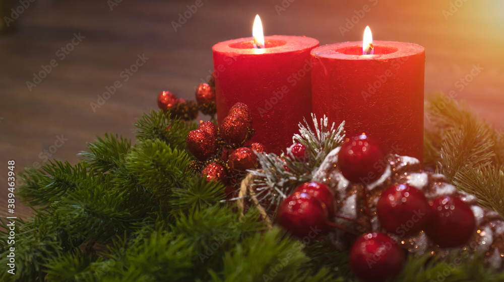 Red candles with fir branches and a toy pine cone. Dark Christmas and New Year background. Red candles, green spruce branches, red berries. Red candles with fir branches and a toy pine cone. Dark Christmas and New Year background. Red candles, green spruce branches, red berries.