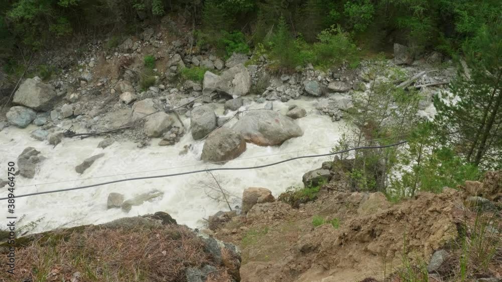 Up view of mountain river. Strong flow of river with splashes Up view of mountain river. Strong flow of river with splashes