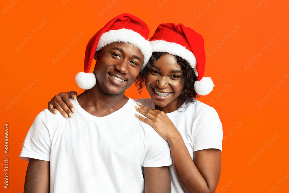Fototapeta premium Cheerful black couple in love celebrating New Year together