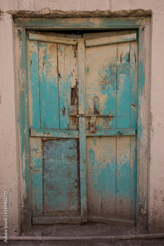 Old wooden door With blue cracked paint
