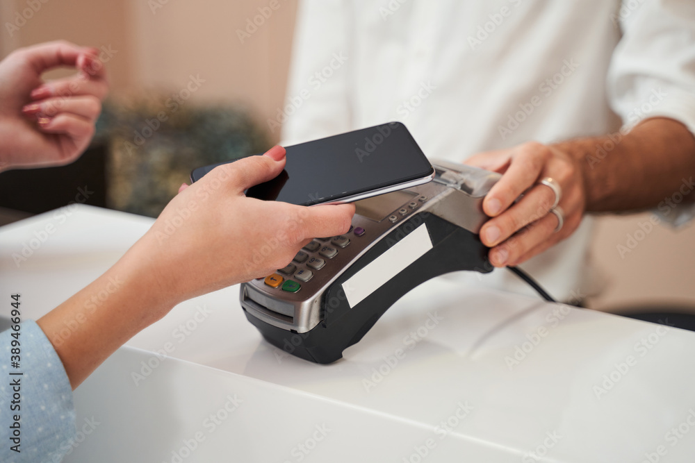 Woman paying with card contactless i Woman paying with card contactless i