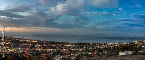 Ventura coast along the Pacific Ocean shines with city lights and colorful clouds before sunrise. © motionshooter
