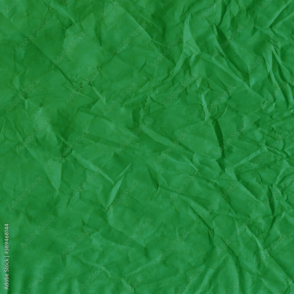 Fototapeta premium Green vintage and old looking crumpled paper background. Retro cardboard texture. Grunge paper for drawing. Ancient book page. Present wrapping.