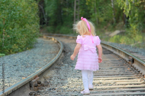 The child walking on the railway. A small girl walk on the railway a zone of increased danger