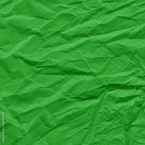 Green vintage and old looking crumpled paper background. Retro cardboard texture. Grunge paper for drawing. Ancient book page. Present wrapping.
