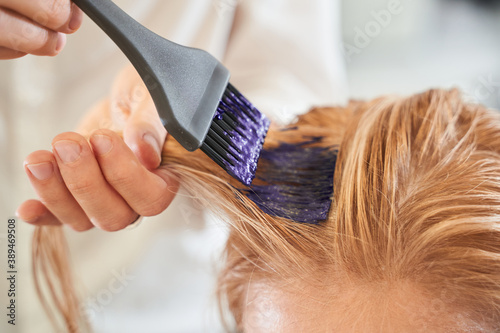 Hairdresser using a brush