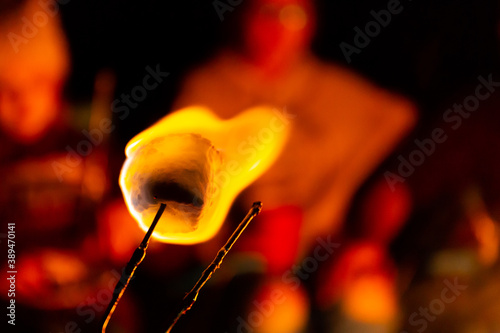 roasting a marshmallow around a campfire to make s'mores