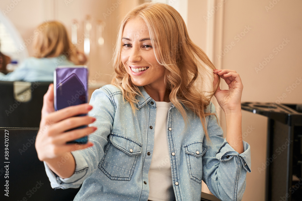 Woman taking a selfie with new hairstyle Woman taking a selfie with new hairstyle