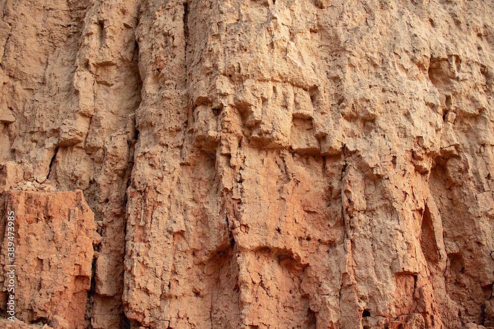 Texture of different layers of clay in clay cliff, photography. Background clay wall or clay cliff, photo