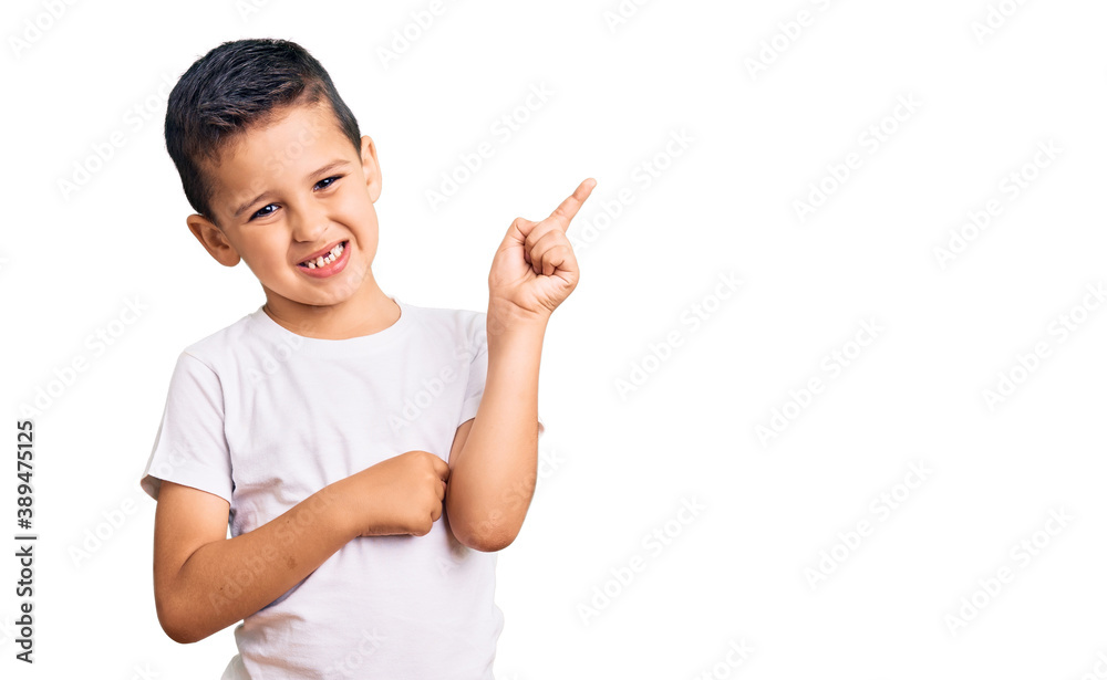 Little cute boy kid wearing casual white tshirt smiling happy pointing with hand and finger to the side Little cute boy kid wearing casual white tshirt smiling happy pointing with hand and finger to the side