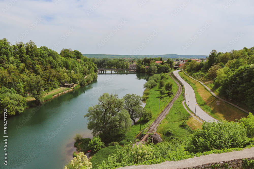 Fototapeta premium Fascinating KUPa river coloured in green as the dense forest in its surroundings, beautiful tourist destination near the city of Karlovac, Croatia