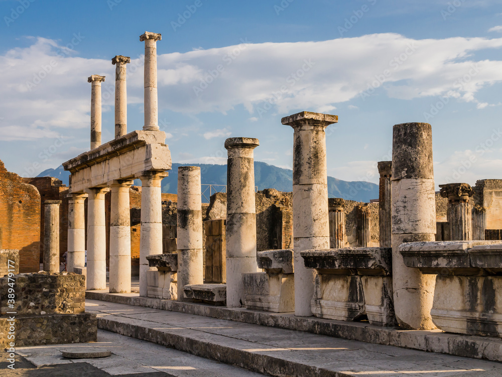 Evocative ruins of the ancient city of Pompeii with columns and capitals, Naples, Italy

