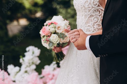 bride and groom holding hands