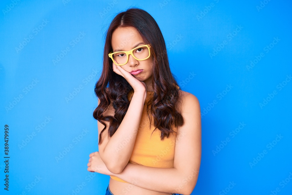 Young beautiful chinese girl wearing casual clothes and glasses thinking looking tired and bored with depression problems with crossed arms.