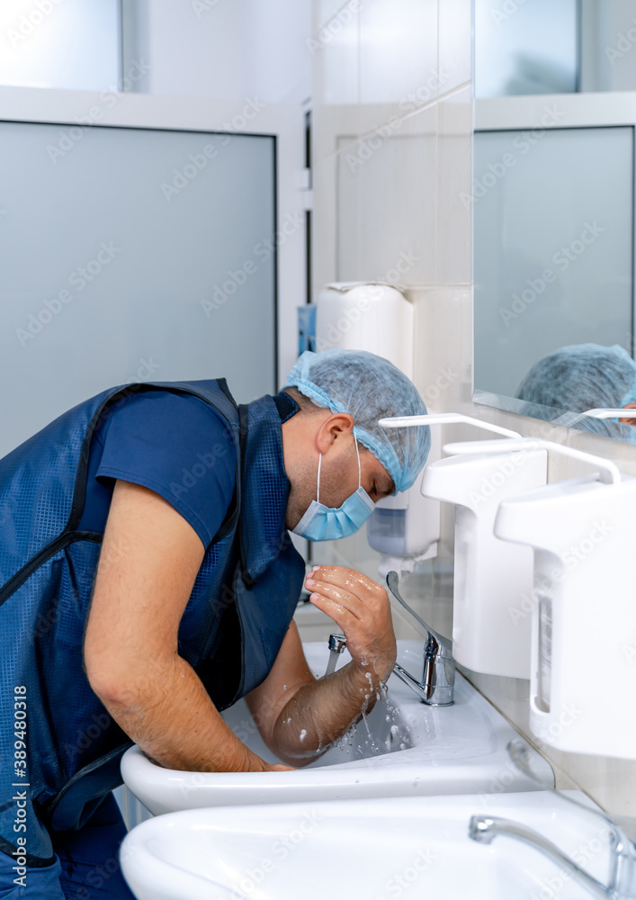 Obraz premium Doctor disinfects hands. Medical specialist washes hands before operation. Surgery.