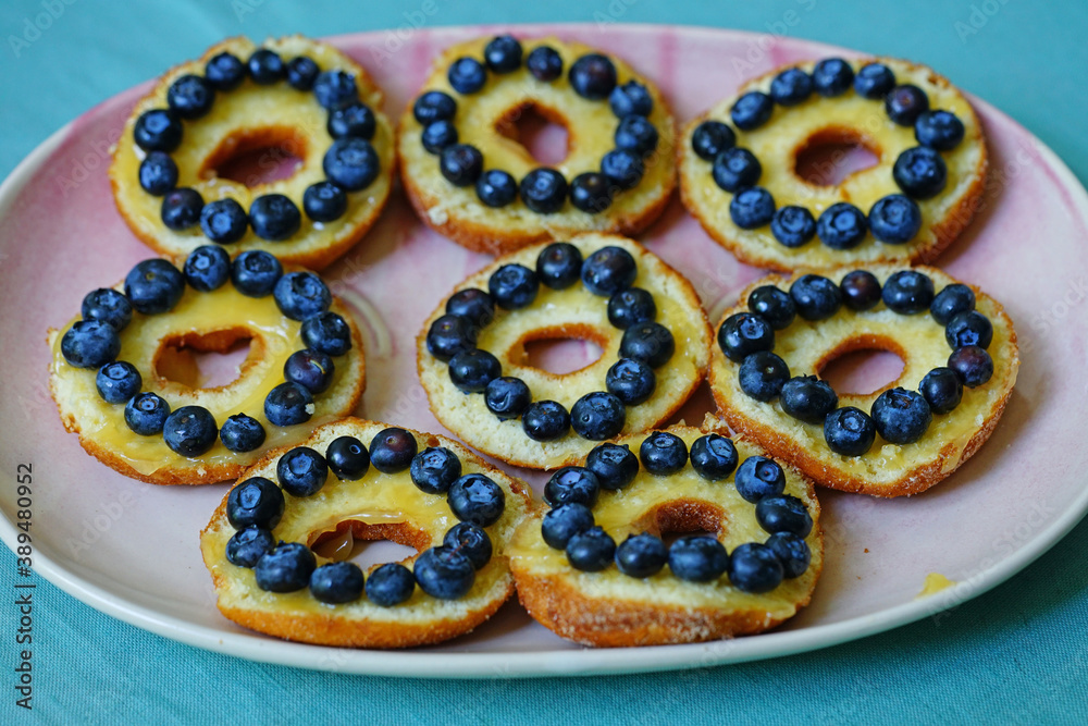Platter of donuts cut in half with lemon curd and fresh blueberries Platter of donuts cut in half with lemon curd and fresh blueberries