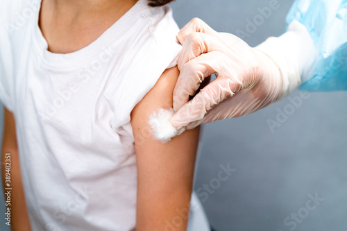 Doctor vaccinating child. Coronavirus vaccination. Covid-19 vaccine at clinic. Little boy getting flu shot. Pediatrician examining kid and giving injection. Virus prevention. Health care.