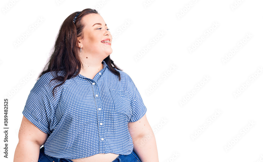 Young plus size woman wearing casual clothes looking away to side with smile on face, natural expression. laughing confident. Young plus size woman wearing casual clothes looking away to side with smile on face, natural expression. laughing confident.
