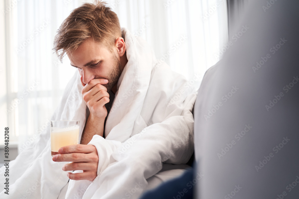 Man drinking an effervescent tablet for a cold Man drinking an effervescent tablet for a cold