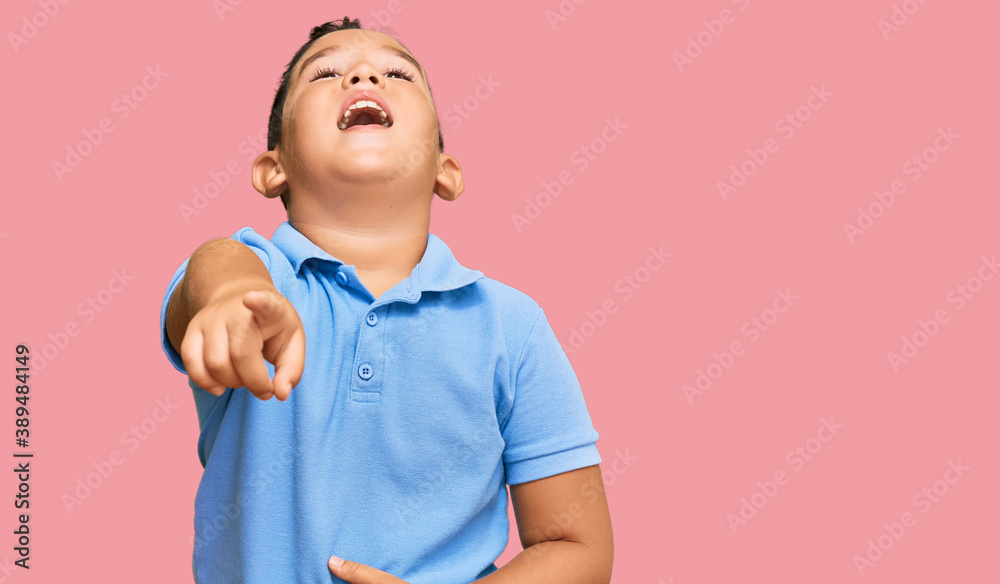 Little boy hispanic kid wearing casual clothes laughing at you, pointing finger to the camera with hand over body, shame expression Little boy hispanic kid wearing casual clothes laughing at you, pointing finger to the camera with hand over body, shame expression