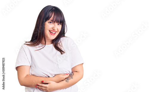 Young plus size woman wearing casual clothes smiling and laughing hard out loud because funny crazy joke with hands on body. © Krakenimages.com