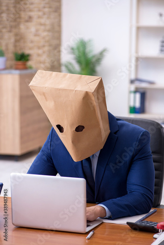 Young male employee with box instead of his head