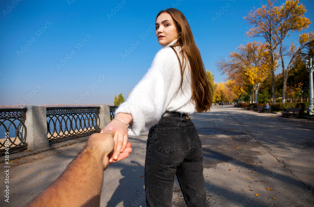 Follow me - young girl holds her boyfriends hand