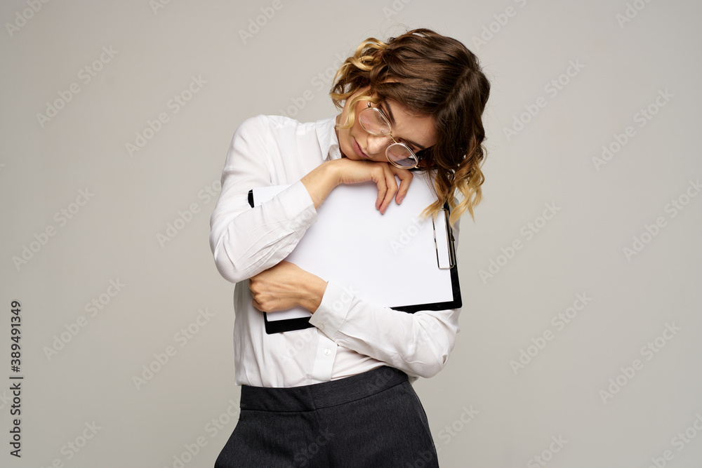 Business woman with folder of documents in hands on gray background cropped view of work Business woman with folder of documents in hands on gray background cropped view of work