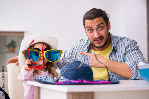 Young man and his small daughter preparing for the trip