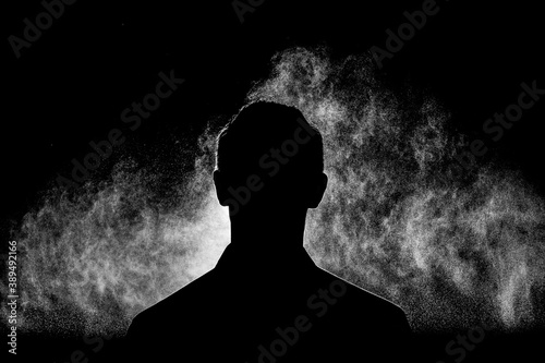 Male silhouette and dust. Black and white composition