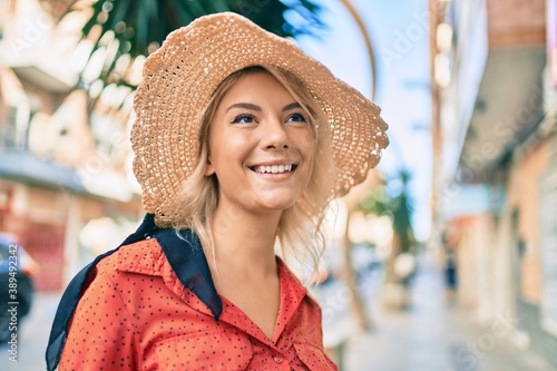 Young blonde tourist woman smiling happy walking at the city.