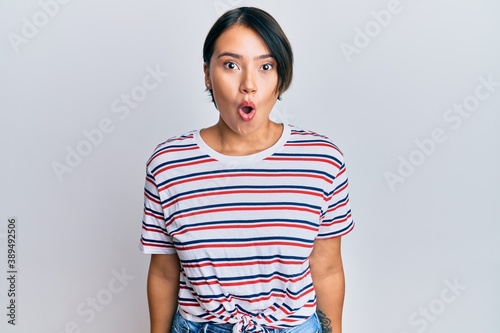 Beautiful young woman with short hair wearing casual clothes scared and amazed with open mouth for surprise, disbelief face