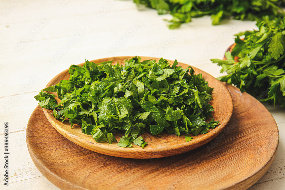 Plate with fresh parsley on table Plate with fresh parsley on table