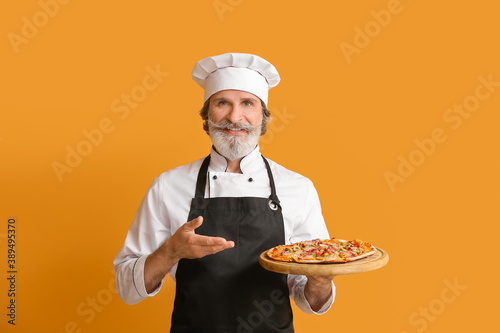 Mature male chef with tasty...